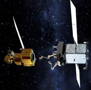 An artist’s conception shows one satellite extending its robotic arm to grasp and refuel another satellite in orbit