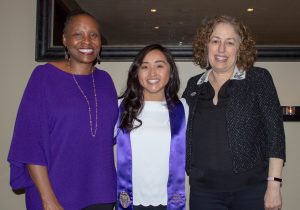 Three women standing next to each other.