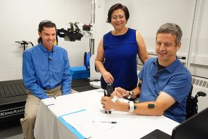 CNT researchers Chet Moritz and Dr. Fatma Inanici work with study participant on grip strength