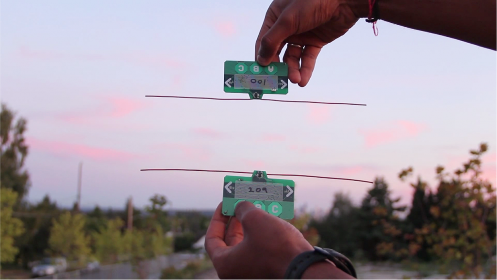 Ambient backscatter devices powered by radio waves from a TV tower in the background. They communicate with one another by selectively reflecting the tower’s radio signals.