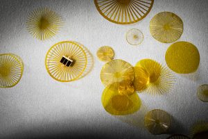 Small, yellow, circular sensors scattered on a white table