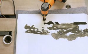 Photo of a robotic arm doing chinese painting
