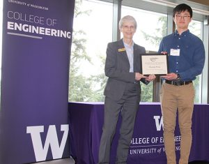 Zhuoran Fang receives his award from Dean Allbritton on stage at the award ceremony