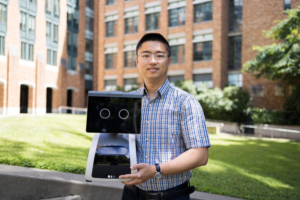 Luocheng Huang with his Amazon Astro robot. photo by Ryan Hoover