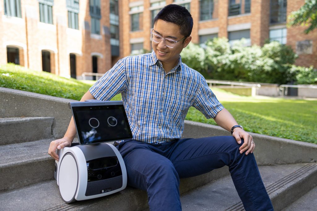 Luocheng Huang with his Amazon Astro robot. photo by Ryan Hoover