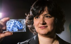 Azadeh Yazdan looking at slide of brain scan