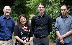 Chris Overly, Stephanie Swanson, Eric Klavins and Ryan Hoover standing together outside of the UW ECE building