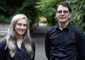 Recent UW ECE graduate and Yang Research Award recipient Zerina Kapetanovic standing next to UW ECE Professor and Chair Eric Klavins