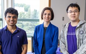 Maryam Fazel smiling at camera with two graduate students