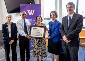 Dean Allbritton, Ganesh and Hema Moorthy, Maryam Fazel, and UW ECE Chair Eric Klavins all standing with certificate for Maryam Fazel