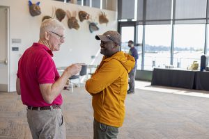 Stephen Wright and Samory Kpotufe talking in the event reception room at the IFDS workshop