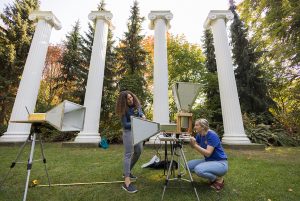 Zerina Kapetanovic and Shanti Garman working with Kapetanovic's wireless communication prototype in Sylvan Grove on the UW campus