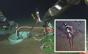 A hydrophone being installed on the ocean floor by a remotely operated vehicle