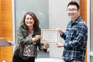 UW ECE Director of Academic Services Stephanie Swanson presenting Matt Guo with the Student Impact Award