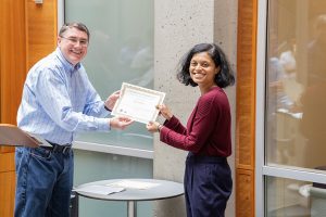 UW ECE Associate Professor presenting Outstanding Teaching Award recipient Shruti Misra with her award certificate