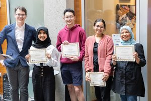 UW ECE Professor and Chair Eric Klavins alongside the UW front desk team with their award certificates. Team members are (from left to right): Rosita Rasyid, Andy Xiong, Padmini Bhagavatula, Ary Prasetyowati, and Vincent Wu (not pictured).