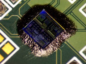 Close-up photo of a tiny microchip mounted to a circuit board