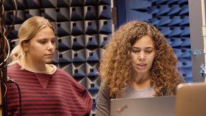 Shanti Garman, at right, reviewing data on a laptop, while a student looks over her shoulder