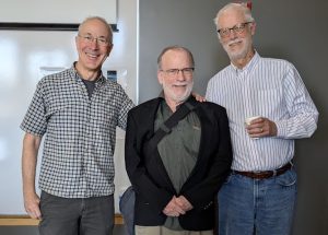 From left to right: UW alumnus David Cohn, UW ECE Professor Emeritus Les Atlas, and Allen School Professor Emeritus Richard Ladner standing next to each other in a room. The men are dressed in business casual apparel, and they are smiling.