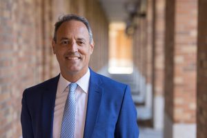 UW ECE and Applied Mathematics Professor Nathan Kutz standing in a brick hallway outside the UW ECE building