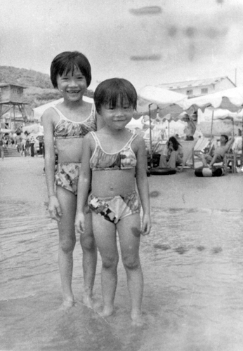 Tran with her sister, Linh, on a beach in Vietnam.