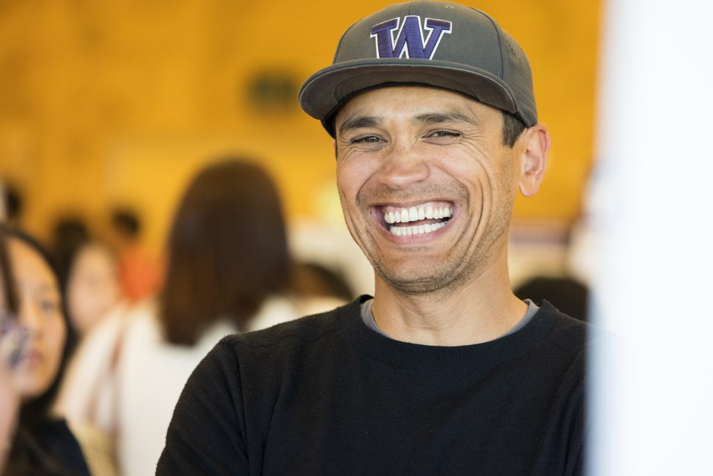 Smiling man with UW hat