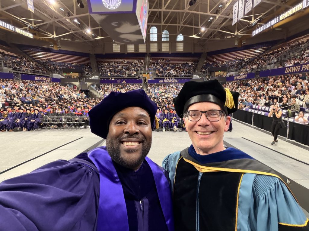 ECE Chair Eric Klavins selfie with Jared Jordan on stage at ECE graduation 2026