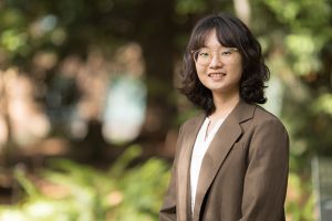 UW ECE Assistant Professor standing outdoors on the UW campus